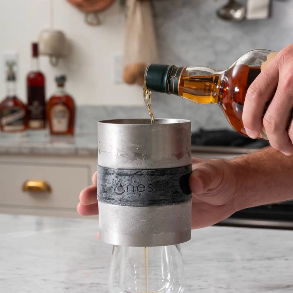 whiskey being poured into container